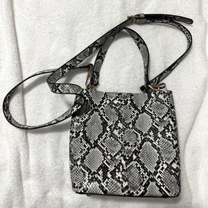 Crossbody handbag/purse faux snake pattern. It is 8”x 4” x 8”